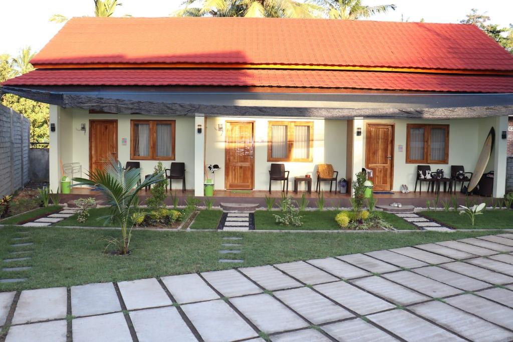 a small house with an orange roof at Room 212 in Kuta Lombok