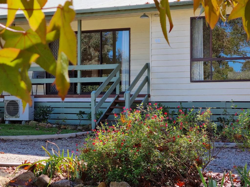 a house with a porch and a staircase at Golden Heritage Apartments Beechworth in Beechworth