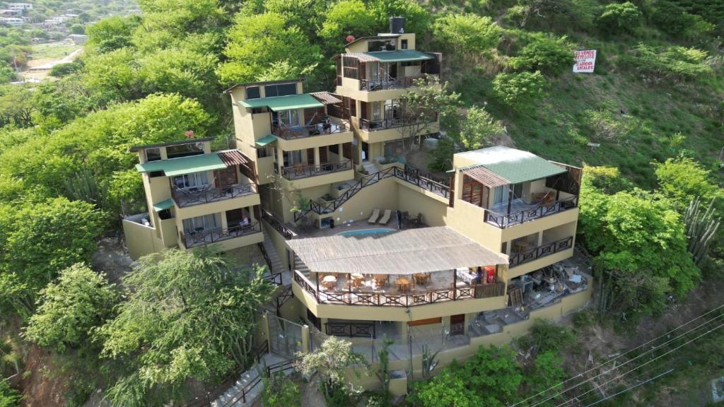an overhead view of a building on a hill with trees at Cabañas Paraiso in Taganga