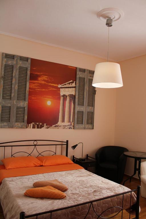 a bedroom with a bed with a painting on the wall at Petaluda House 1 in Athens