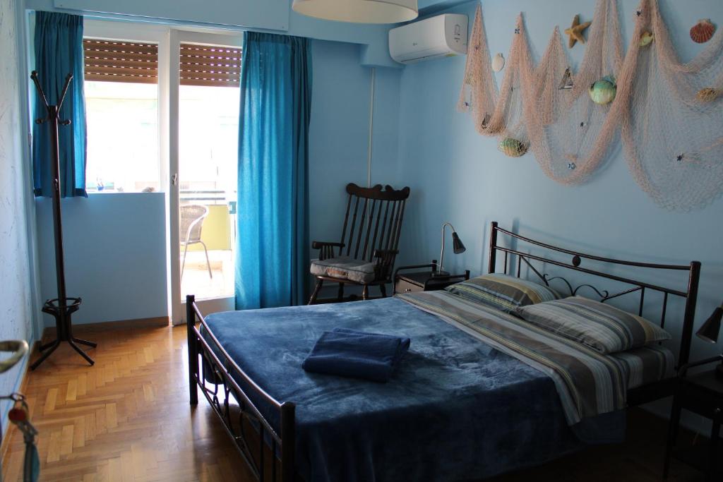 a bedroom with a bed with a blue wall at Petaluda House 1 in Athens