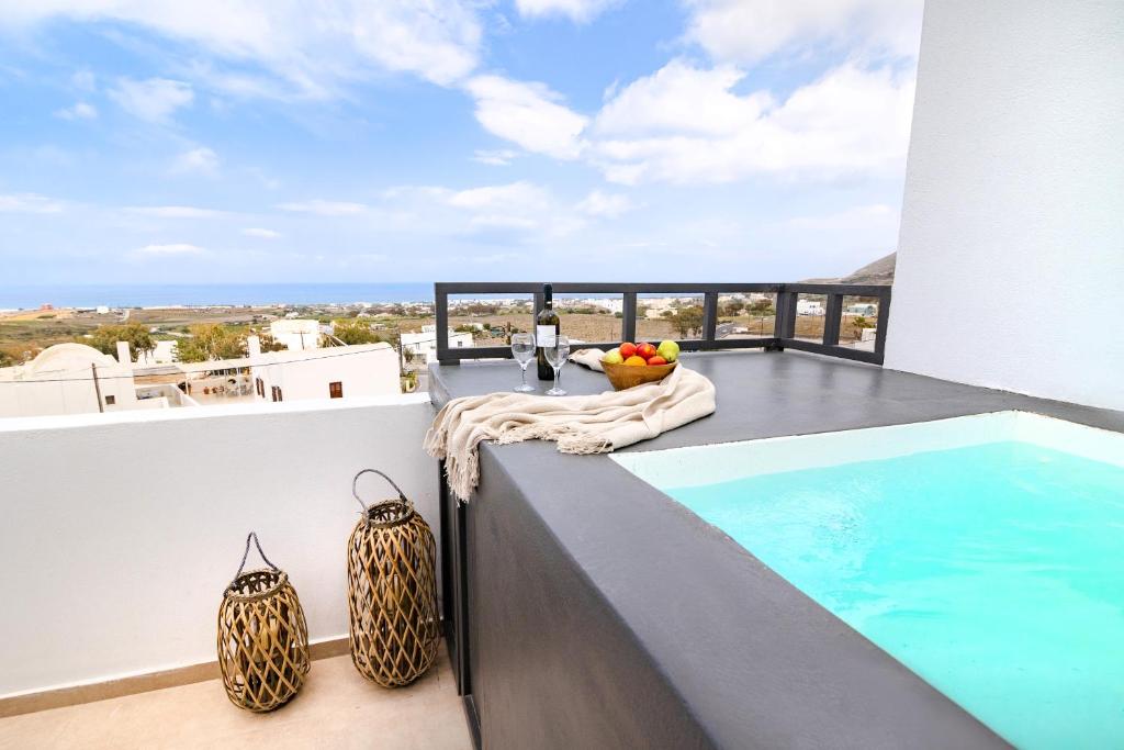 a balcony with a swimming pool on top of a building at WHITE BREEZE VILLAS in Éxo Goniá