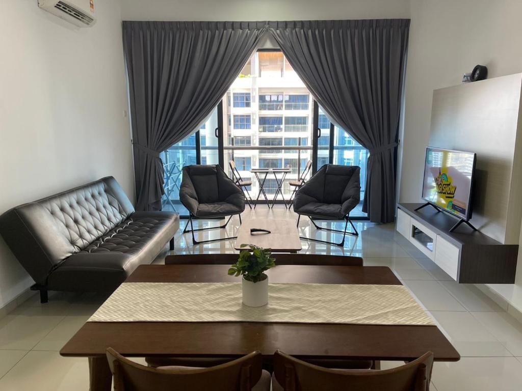 a living room with a couch and a table at Atlantis Residence Batik Travel in Tranquerah