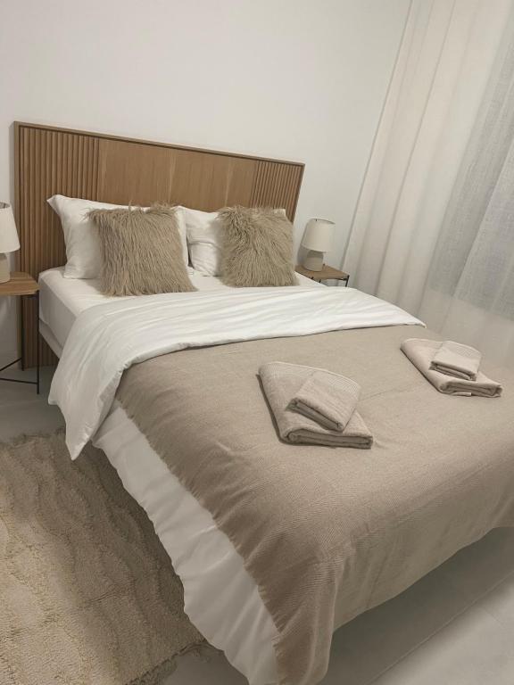 a large bed with two towels on top of it at Vanian Gardens Apartment -Stella in Estepona