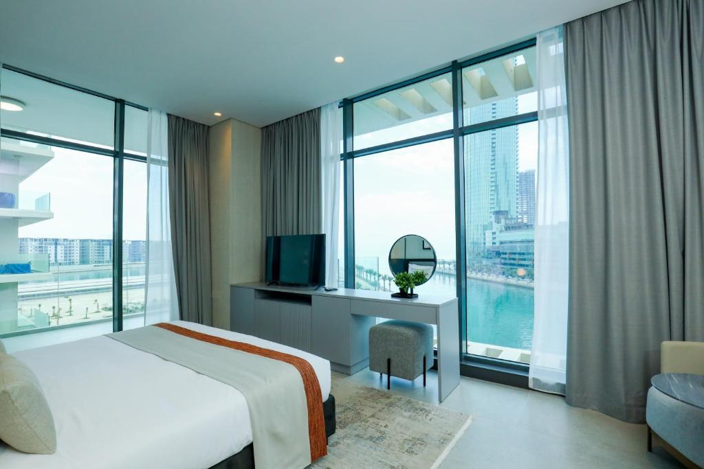 a hotel room with a bed and a large window at Charthouse Bahrain in Manama
