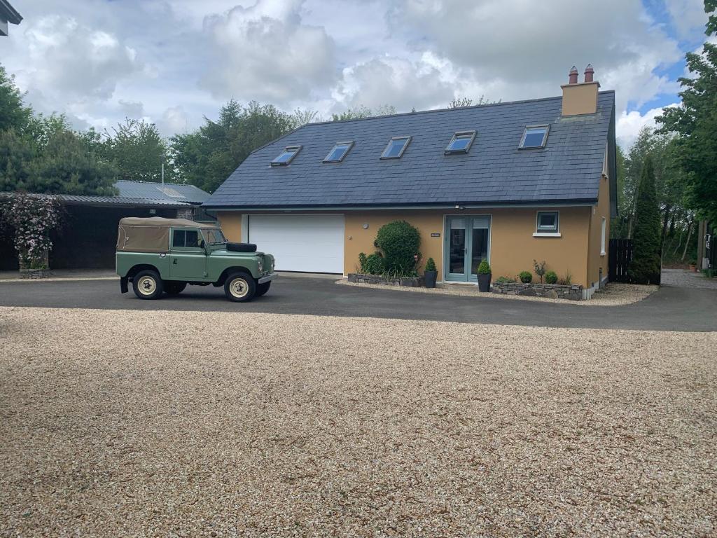 a green truck parked in front of a house at The Mews in Newbridge
