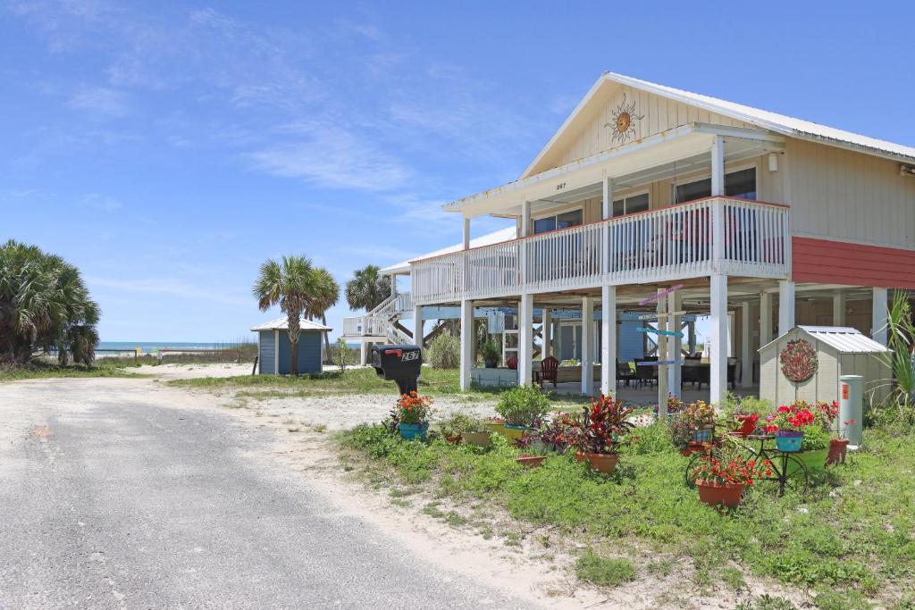 a house with flowers on the side of a road at Summer Breeze by Pristine Properties Vacation Rentals in Indian Pass