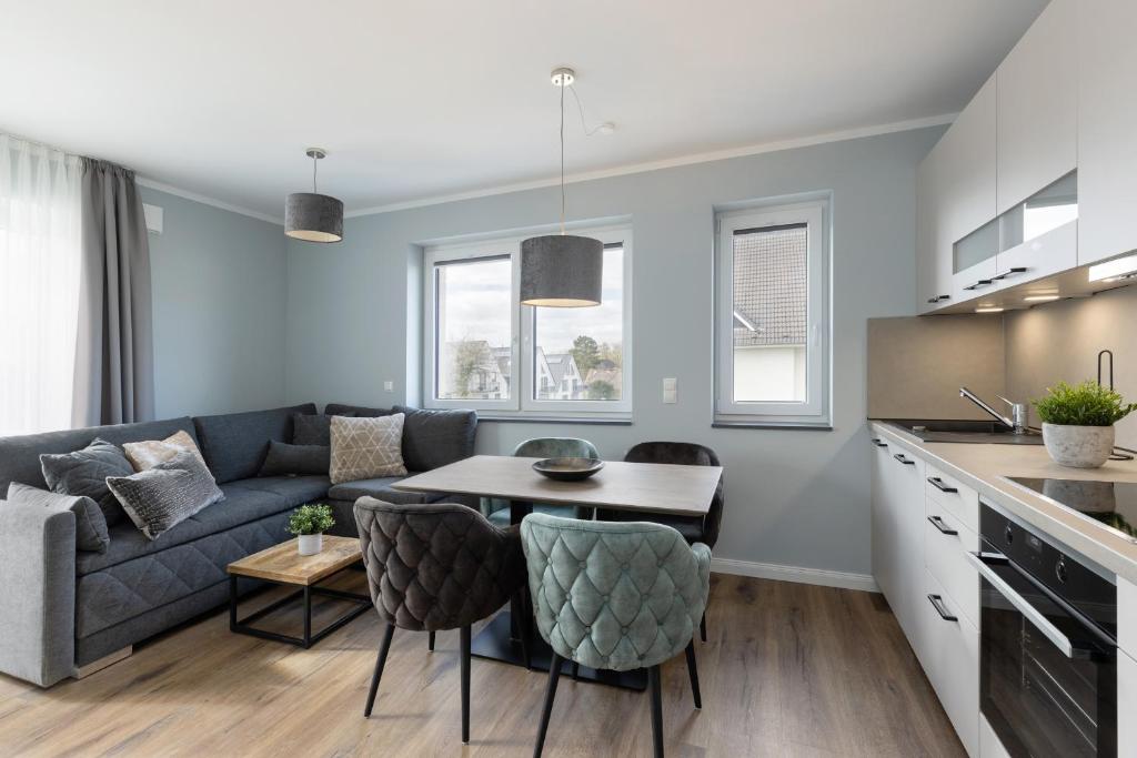 a living room with a couch and a table at Sturmfrei Suite 8 in Scharbeutz