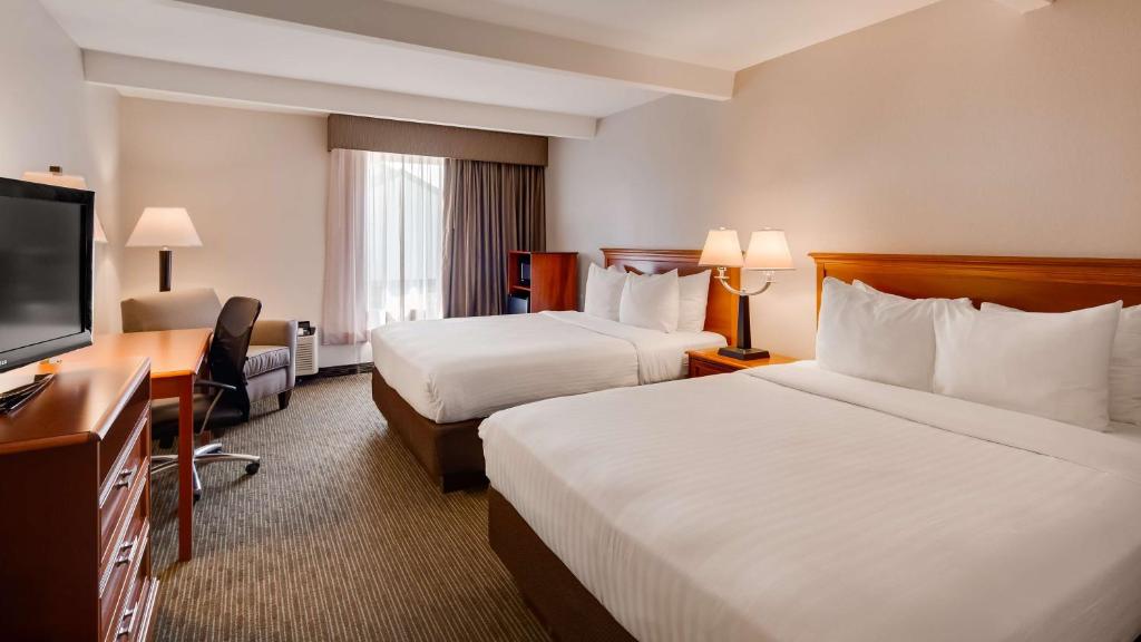 En eller flere senge i et værelse på Best Western Tomah Hotel