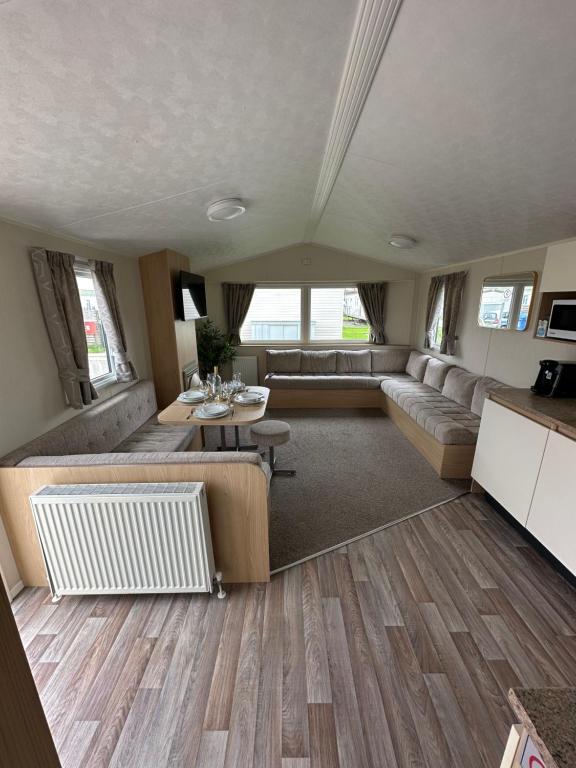 a living room with a couch and a table at Sunnymede 2 Keyshare Holiday lets in Skegness