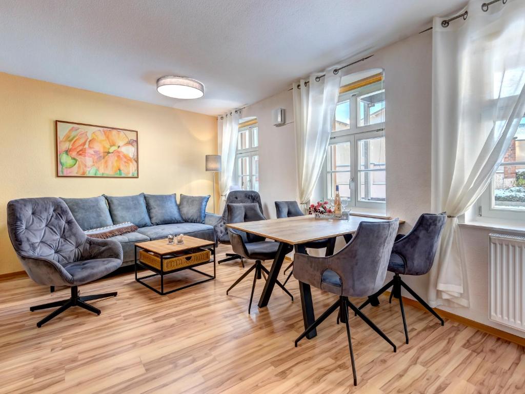 a living room with a couch and a table at Villa Bellevue App. 8 in Ahlbeck