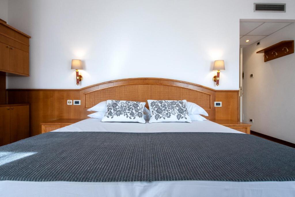 Postel nebo postele na pokoji v ubytování Hotel Metropole