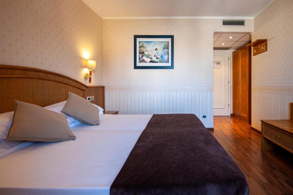 Postel nebo postele na pokoji v ubytování Hotel Metropole