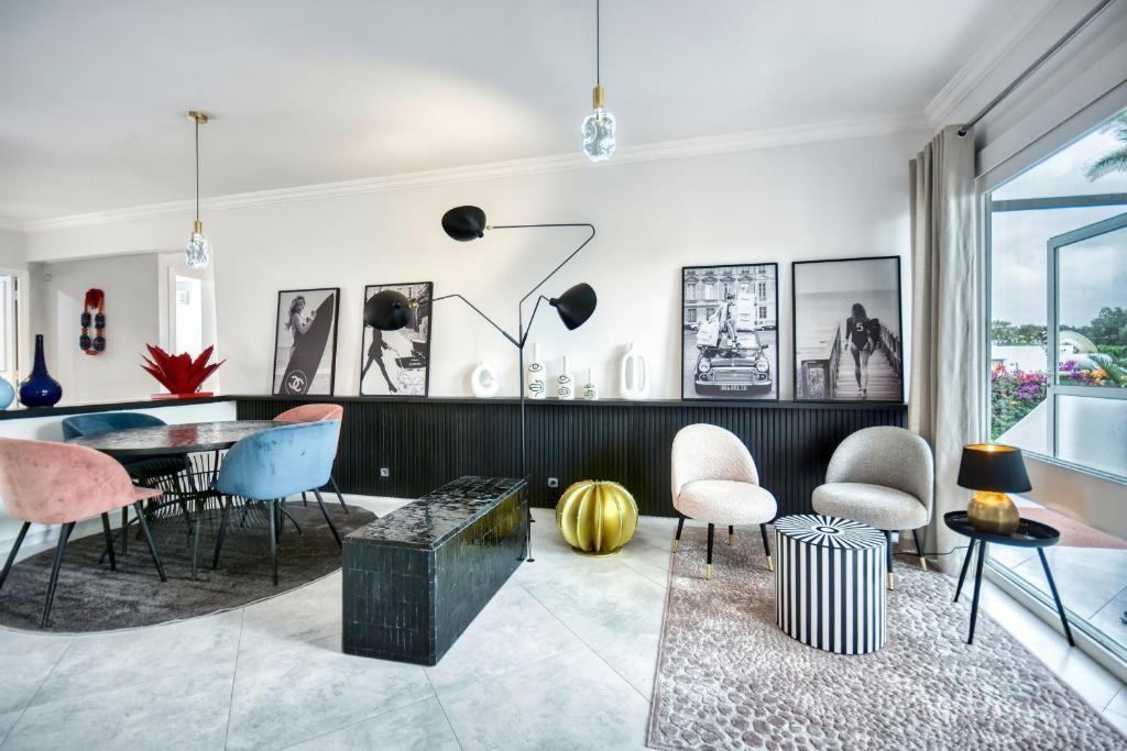 a living room with a table and chairs at Signature Agadir Villa Luxe for 4 or 6 PX in Agadir