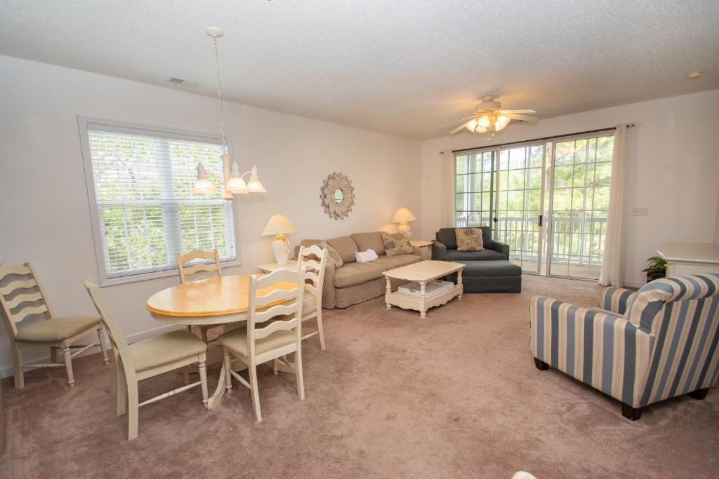 a living room with a table and a couch at Iron Wood 1721 by Palmetto Vacation Rentals in Myrtle Beach