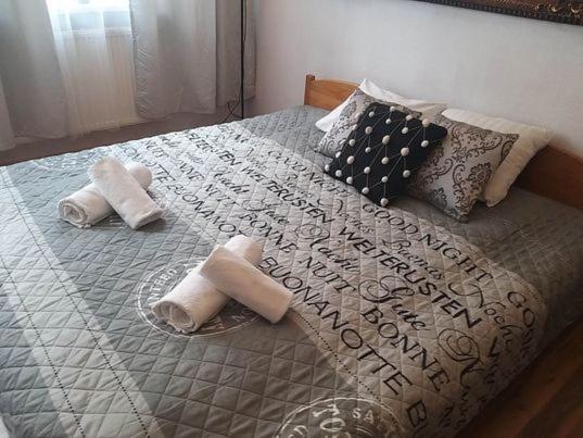 a bed with two towels and pillows on it at Apartment Kazimierz Rzeszowska in Krakow