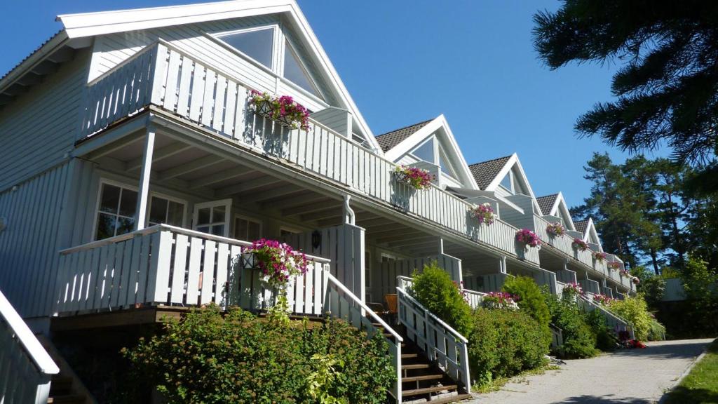 une maison avec des fleurs sur ses balcons dans l'établissement Bergland apartment 18 - close to the center of Kragerø, à Kragerø