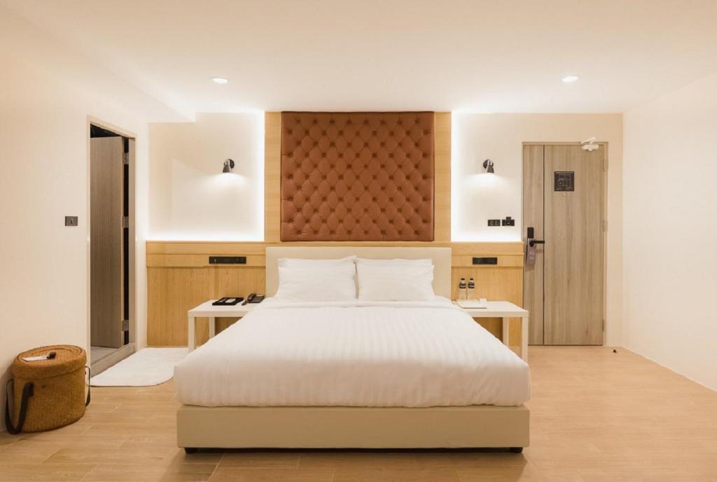 a bedroom with a white bed and a desk at Heaven Boutique Hotel in Bangkok