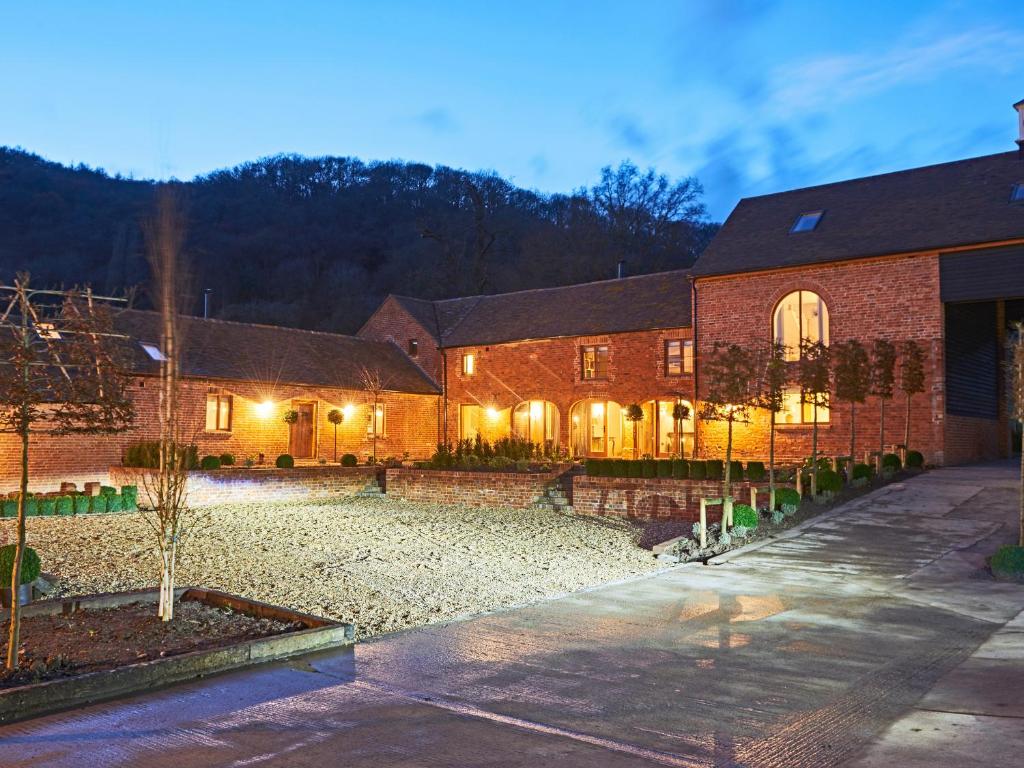 a brick building with a courtyard in front of it at The Millhouse in Ledbury