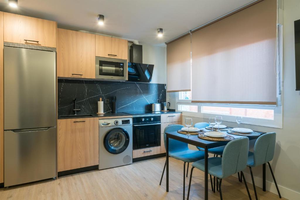 cocina con mesa, fogones y lavavajillas en Villa Hita apartment by People Rentals, en Bilbao