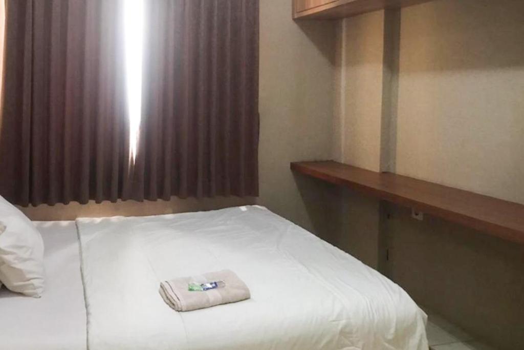 Postel nebo postele na pokoji v ubytování Apartemen The Edge Baros - Kamarku