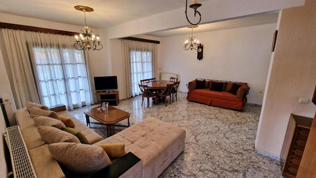 a living room with a couch and a table at Fani apartment in Ouranoupoli