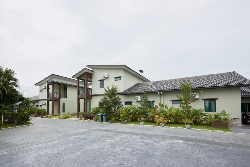 a house with a driveway in front of it at D' Qamar Guesthouse in Kuantan