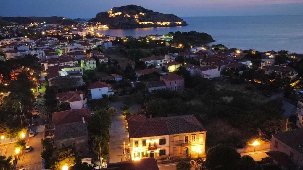 a view of a city at night at Artemis Traditional Hotel in Myrina