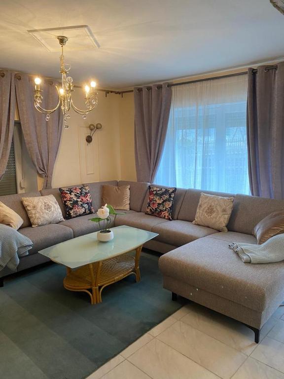 a living room with a couch and a table at Sinan's Bio Tourismus Farm Appartement in Betteldorf