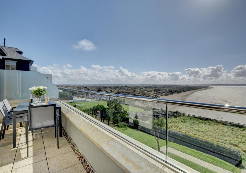 a balcony with a view of the ocean at 10 Ocean Point in Croyde