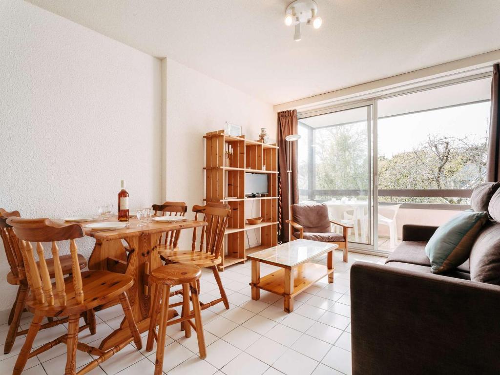 un salon avec une table, des chaises et un canapé dans l'établissement Carnac - Studio cabine proche plage avec parking et animaux acceptés - FR-1-477-139, à Carnac