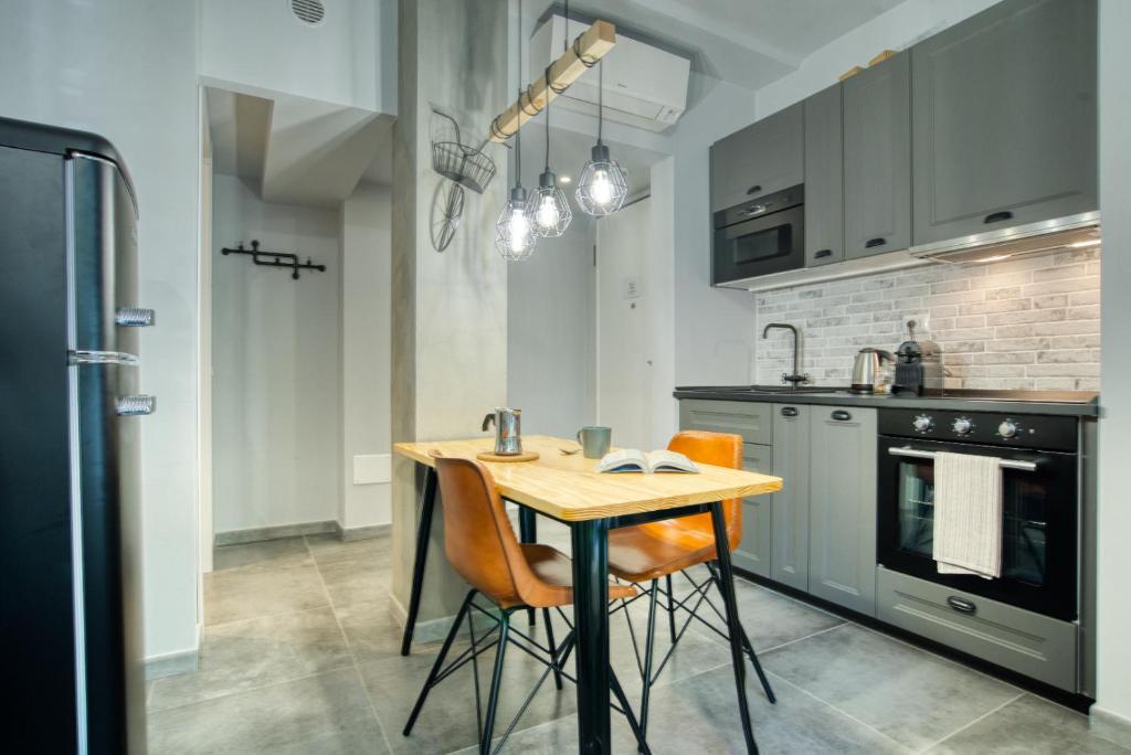 a kitchen with a wooden table and chairs in it at Italianflat - Angolino dei navigli in Milan