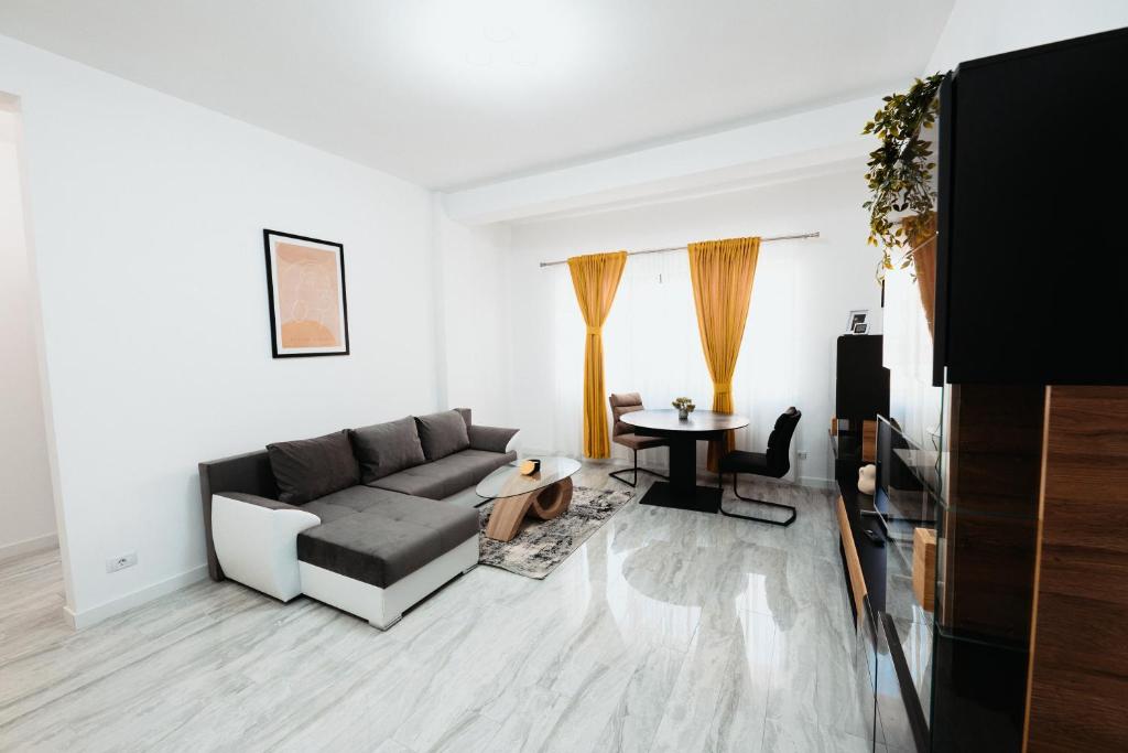 a living room with a couch and a table at Cozy Aparthotel - Central City Suceava in Suceava