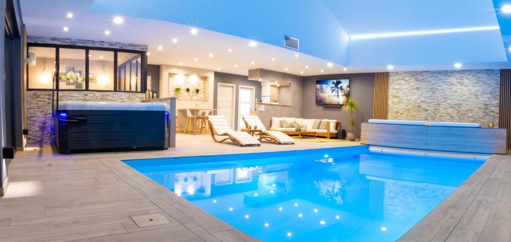 a house with a swimming pool and a living room at Gite O² 