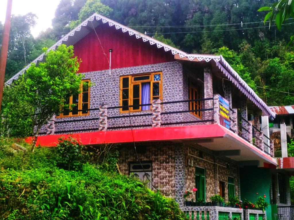a small house with a red roof at Blessing Homestay Ahaldara in Mangpu