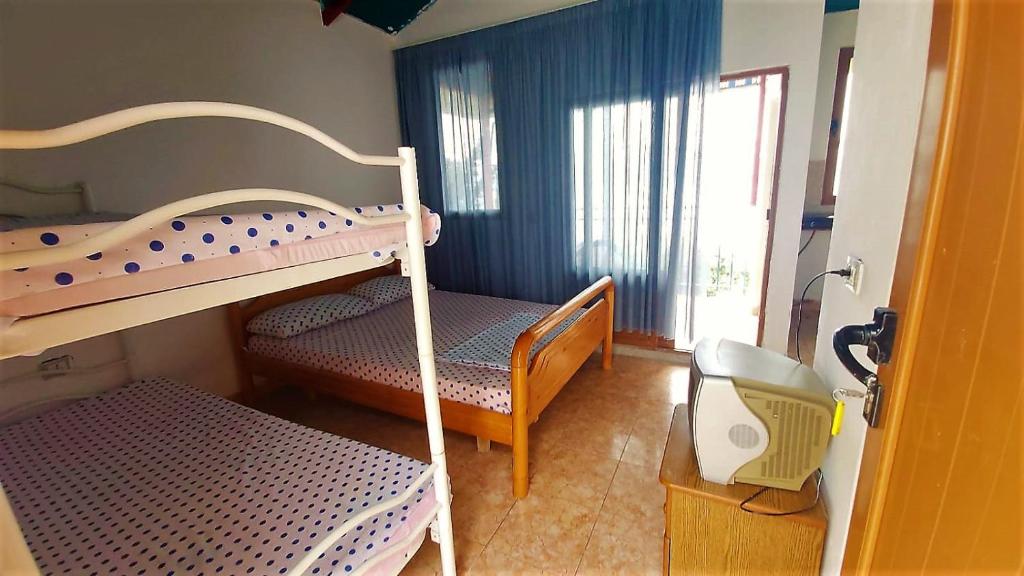 Second Room of Cozy Beachside Haven - Panoramic Radhime Retreat with Balcony Dining - Image 2