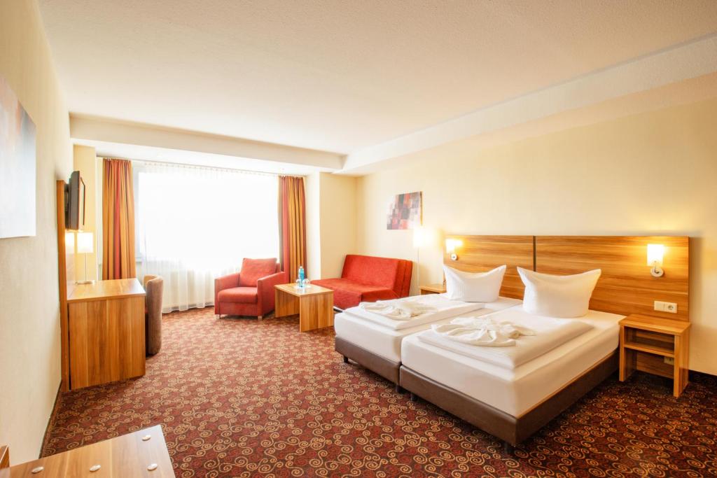 Ένα ή περισσότερα κρεβάτια σε δωμάτιο στο Ferien Hotel Rennsteigblick