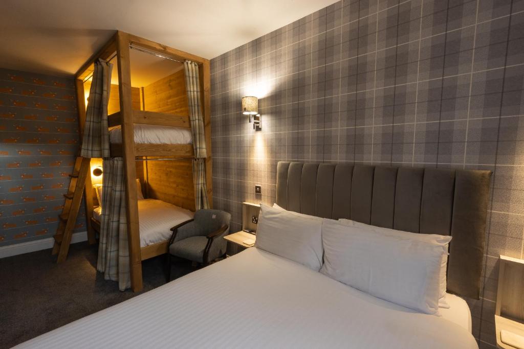 a bedroom with a bed and a bunk bed with a mirror at Aye Stay in Inverness