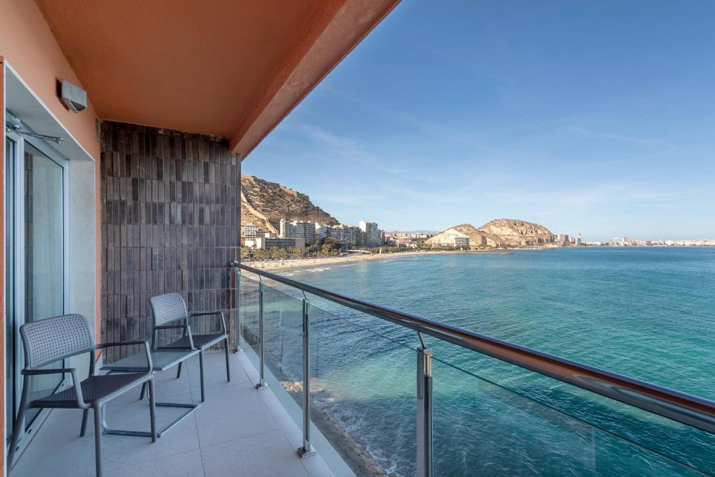a balcony with chairs and a view of the ocean at INNSiDE by Meliá Alicante Porta Maris in Alicante