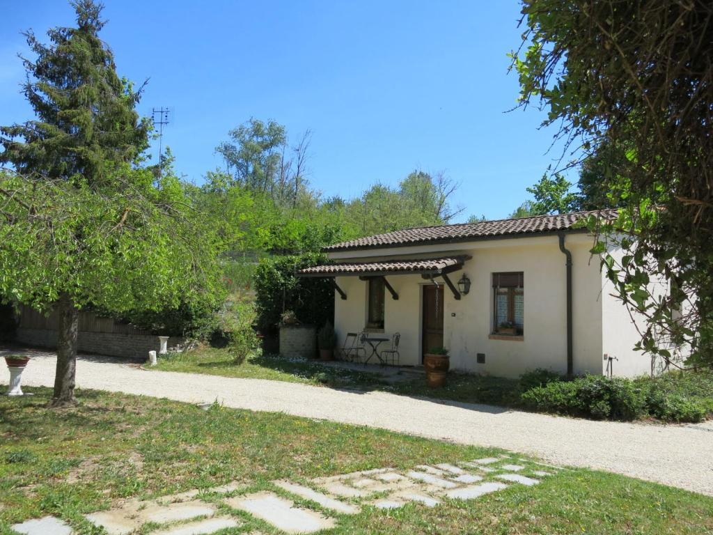 a house with a garden and a gravel driveway at Holiday Home I Grilli by Interhome in Castagnole Lanze