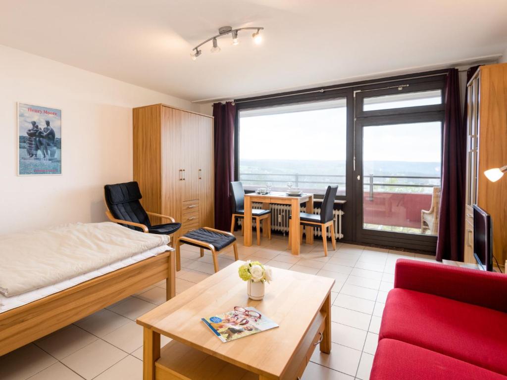 a hotel room with a bed and a table and chairs at Apartment A410 by Interhome in Lahnstein