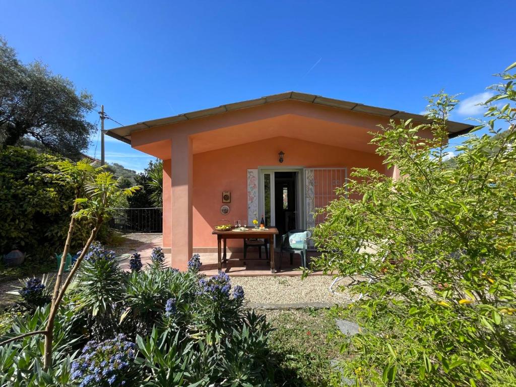 een klein huis met een tafel in een tuin bij Holiday Home Casa dei Nonni - IMP425 by Interhome in Imperia