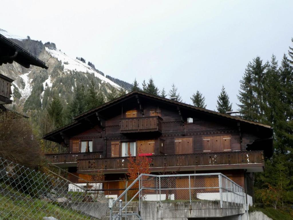 a building on the side of a mountain at Apartment Chalet Waldchutz - 2- Stock by Interhome in Lenk
