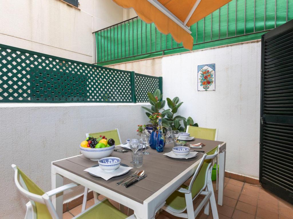 a table with a bowl of fruit on it at Apartment Pomeres by Interhome in Tossa de Mar