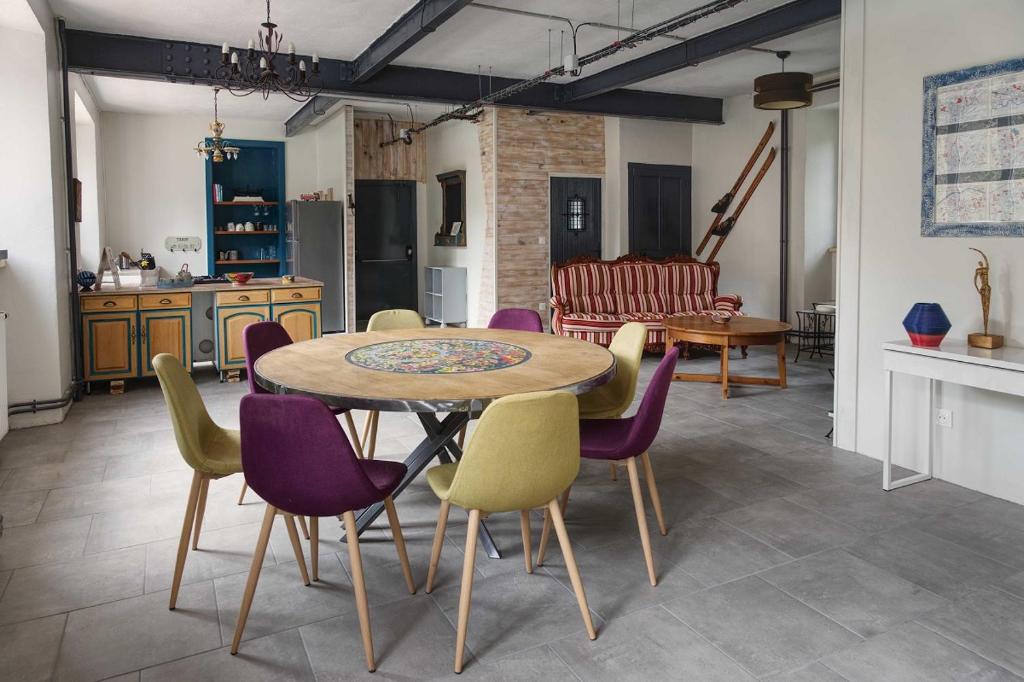 a kitchen and dining room with a table and chairs at L'Ancienne Colonie - maison conviviale au bord de la Gazeille - 8 pers in Le Monastier sur Gazeille