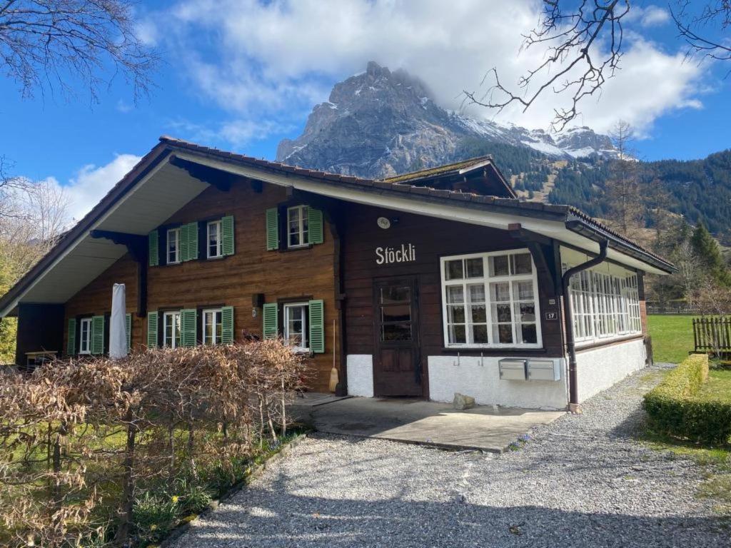 a building with a mountain in the background at Apartment Chalet Stöckli by Interhome in Kandersteg