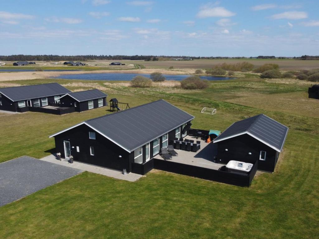 an overhead view of two black houses on a field at Holiday Home Dwerg - 1-5km from the sea in NW Jutland by Interhome in Løkken