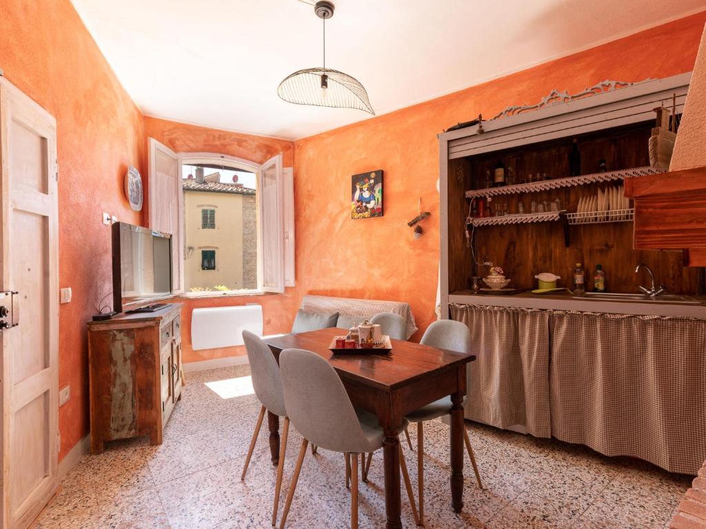 a kitchen with a table and chairs in a room at Apartment Bilocale dell'Arco by Interhome in Massa Marittima