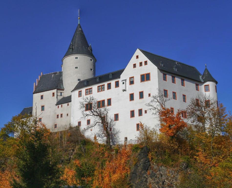 a large white castle with a tower on a hill at Zum Pieck Schwarzenberg in Schwarzenberg/Erzgebirge