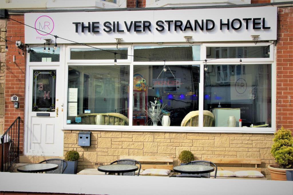 a group of tables and chairs in front of a hotel at MyRoomz Silver Strand Hotel in Blackpool